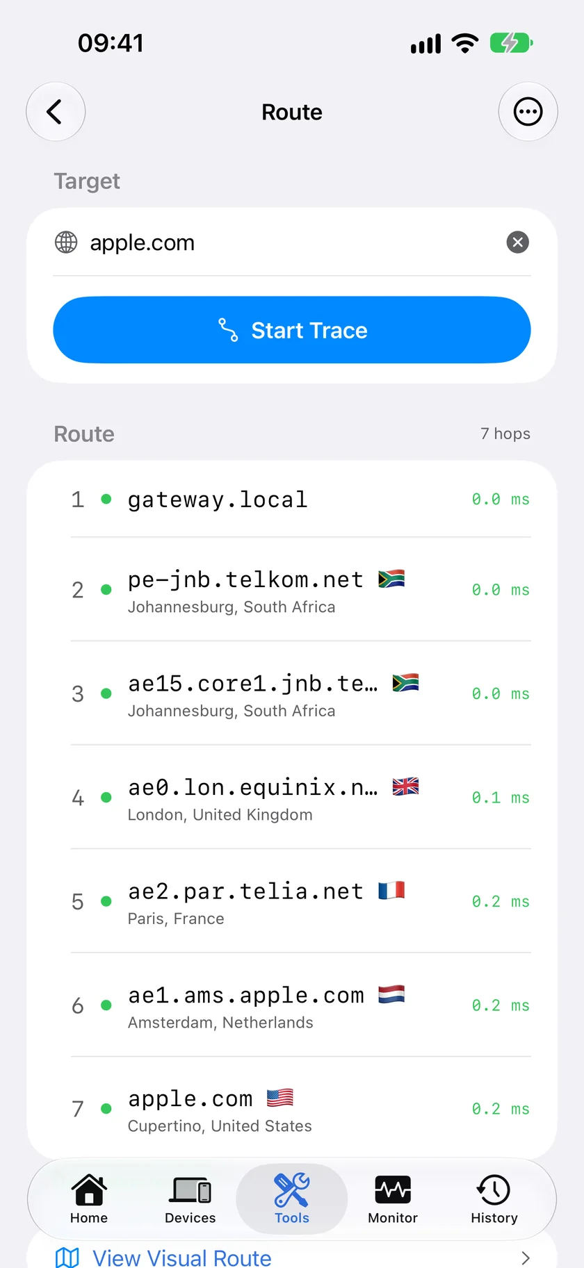 A completed visual traceroute in PingKit for iPhone, listing seven hops from the local gateway to apple.com with the city and country of each and its round-trip time.